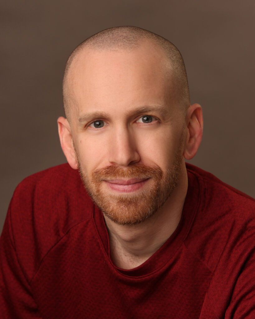 Matt Nelson Voice Actor Smiling in Red Shirt